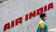 A woman walks past Air India airlines branding in Mumbai, India, October 19, 2021. (REUTERS/Francis Mascarenhas)