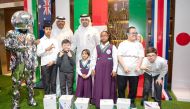 Ooredoo officials with students from Al Shafallah Center during ‘Meet the Trophy’ event at Ooredoo Tower, West Bay in Doha, recently.