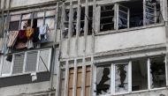 A local woman speaks on her mobile phone in a window of a residential building damaged by a Russian military strike, amid Russia's attack on Ukraine continues, in Kherson, Ukraine December 1, 2022.  File Photo / Reuters