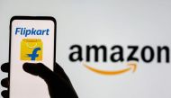 Smartphone with Flipkart logo is seen in front of displayed Amazon logo in this illustration taken July 30, 2021. (REUTERS/Dado Ruvic)