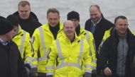 German Chancellor Olaf Scholz (centre), German Finance Minister Christian Lindner (fourth left) and German Minister of Economics and Climate Protection Robert Habeck (behind Scholz, right) arrive for the opening ceremony of the Uniper Liquefied Natural Gas (LNG) terminal at the Jade Bight in Wilhelmshaven, northern Germany on December 17, 2022. (Photo by FOCKE STRANGMANN / AFP)
 