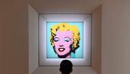 In this file photo taken on April 29, 2022 a man looks at Andy Warhol's 'Shot Sage Blue Marilyn' during Christie's 20th and 21st Century Art press preview at Christie's New York in New York City. (Photo by Angela Weiss / AFP)