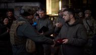 Ukraine's President Volodymyr Zelenskiy awards a Ukrainian service member at a position in the frontline town of Bakhmut in Donetsk region, Ukraine December 20, 2022. Ukrainian Presidential Press Service/Handout via Reuters