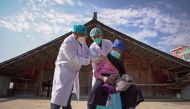 An elderly woman receives a Covid-19 vaccine in Danzhai, in China's southwestern Guizhou province province on December 21, 2022. (AFP) 

