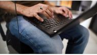 File photo: An employee works on a laptop at the headquarters of security system developer Staqu Technologies Pvt. in Gurugram, Haryana, India, on September 10, 2019. (Anindito Mukherjee/Bloomberg)