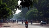 People ride bicycles and motorcycles on a street in Ouagadougou, Burkina Faso, on September 17, 2015. File Photo / Reuters




