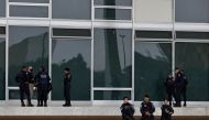 Police officers stand guard as indigenous people (not pictured) supporting President Jair Bolsonaro protest in front of the Supreme Court, in Brasilia, Brazil, December 25, 2022. (REUTERS/Ueslei Marcelino)