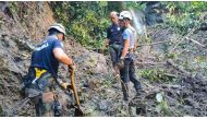 In this handout photo from Mati City Disaster Risk Reduction Management Office taken on December 29, 2022, shows rescuers searching for missing people following a landslide in Mati City, Davao Oriental. Photo by Handout / Mati City Disaster Risk Reduction Management Office / AFP
