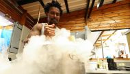 Tapi Tapi ice cream shop owner, Zimbabwean Tapiwa Guzha, mixes dry ice into the ice cream ingredients at his shop in Observatory, in Cape Town, South Africa, December 21, 2022. REUTERS/Esa Alexander
