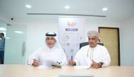 Deputy CEO of Dar Al Sharq, Jaber Salem Al Harami (left) and Editor-in-Chief of Al Roya Newspaper Hatem bin Hamad Al Taie signing the MoU.