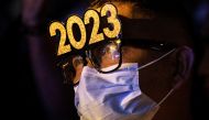 A man attends a New Year's Eve party wearing glasses with the year 2023, in Quezon City, Metro Manila, Philippines, December 31, 2022. REUTERS/Eloisa Lopez