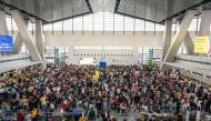 Passengers wait for information about their flights at terminal 3 of Ninoy International Airport in Pasay, Metro Manila on January 1, 2023. (Photo by KEVIN TRISTAN ESPIRITU / AFP)

