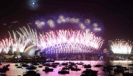 New Year's Eve fireworks light up the sky over the Sydney Opera House (L) and Harbour Bridge during the fireworks display in Sydney on January 1, 2023. (Photo by David Gray / AFP)