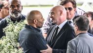FIFA President Gianni Infantino greets the son of Brazilian football legend Pele, Edinho, during his wake at the Urbano Caldeira stadium in Santos, Sao Paulo, Brazil on January 2, 2023. (Photo by NELSON ALMEIDA / AFP)