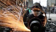 A worker polishes a bicycle steel rim at a factory manufacturing sports equipment in Hangzhou, Zhejiang province, China. (REUTERS)