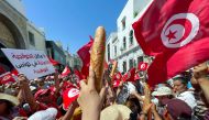 Demonstrators hold loaves of bread as they protest in opposition to a referendum on a new constitution called by President Kais Saied, in Tunis, Tunisia June 18, 2022. File Photo / Reuters