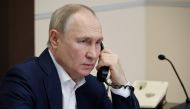 Russian President Vladimir Putin talks on the phone with Agatha Bylkova, an eight-year-old girl from the Kurgan region who took part in the New Year Tree of Wishes nationwide charity campaign, in Moscow on January 3, 2023. (Photo by MIKHAIL KLIMENTYEV / SPUTNIK / AFP)