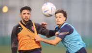 Al Duhail's Bassam Al Rawi (left) in action with a team-mate during a training session.