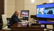 Russian President Vladimir Putin listens to the report by Defence Minister Sergei Shoigu and Commander of the Admiral Gorshkov frigate Igor Krokhmal before a ceremony to launch the Admiral Gorshkov frigate to the combat mission, via video link in Moscow, Russia, on January 4, 2023. Sputnik/Mikhail Klimentyev/Kremlin via REUTERS