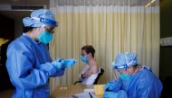 A nurse prepares a shot for Jonathan Halter as the German embassy begins its roll out of BioNTech COVID-19 vaccines for German expatriates at a Beijing United Family hospital in Beijing, China January 5, 2023. REUTERS/Thomas Peter