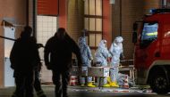 Agents wearing protective suits examine substances on the premises of the fire brigade in Castrop-Rauxel, western Germany on January 8, 2023 following arrests on suspicion of preparing an attack using cyanide and ricin. (Photo by Christoph Reichwein / DPA / AFP)
