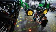 The new sprayers developed by agricultural giant John Deere, and displayed at the 2023 CES technology show in Las Vegas, Nevada, apply pesticides only where their cameras have detected weeds. (Patrick T. Fallon / AFP)