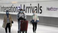 Passengers walk through the International arrivals area of Terminal 5 in London's Heathrow Airport, Britain, August 2, 2021. REUTERS/Peter Nicholls
