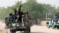 Nigerian military ride on their truck as they secure the area where a man was killed by suspected militants during an attack around Polo area of Maiduguri, Nigeria, on February 16, 2019. File Photo / Reuters
