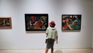 File Photo: A woman watches the exhibition 'Genealogies of the art, or art history as visual art' at the Picasso Museum in Malaga, Spain, May 26, 2020. (REUTERS/Jon Nazca)