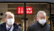 Pedestrians walk in front of a Uniqlo store operated by Japan's Fast Retailing in Tokyo on January 11, 2023. (Photo by Philip FONG / AFP)
