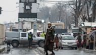 A member of Taliban security force stands guard on a blocked road after a suicide blast near Afghanistan's foreign ministry at the Zanbaq Square in Kabul on January 11, 2023.  (Photo by Wakil KOHSAR / AFP)