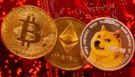 Representations of Cryptocurrencies Bitcoin, Ethereum and DogeCoin are placed on PC motherboard in this illustration taken, June 29, 2021. (REUTERS/Dado Ruvic)