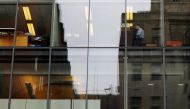 A worker sits at his desk in an office building in Washington, U.S., August 3, 2018. REUTERS/Brian Snyder/File Photo
