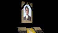 The portrait of former Japanese Prime Minister Shinzo Abe is seen at the altar during his state funeral at Nippon Budokan, in Tokyo, Japan, September, 27, 2022. Eugene Hoshiko/Pool via REUTERS/File Photo
