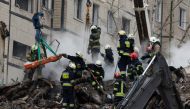 Emergency personnel retrieve a dead body at the site where an apartment block was heavily damaged by a Russian missile strike, amid Russia's attack on Ukraine, in Dnipro, Ukraine January 15, 2023. REUTERS/Clodagh Kilcoyne