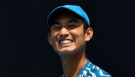 China's Shang Juncheng reacts on a point against Germany's Oscar Otte during their men's singles match on day one of the Australian Open tennis tournament in Melbourne on January 16, 2023. (Photo by Paul CROCK / AFP)