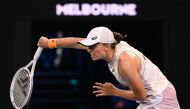 Poland's Iga Swiatek hits a return against Germany's Jule Niemeier during their women's singles match on day one of the Australian Open tennis tournament in Melbourne on January 16, 2023. (Photo by WILLIAM WEST / AFP) 
