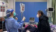 A medical worker checks the IV drip treatment of a patient lying on a bed in the emergency department of a hospital, amid the coronavirus disease (COVID-19) outbreak in Shanghai, China, on January 5, 2023. REUTERS/Staff/File Photo

