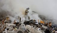 Emergency personnel work among debris at the site where a building was heavily damaged in recent shelling in the course of Russia-Ukraine conflict in Donetsk, Russian-controlled Ukraine, on January 16, 2023. REUTERS/Alexander Ermochenko
