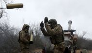 Ukrainian artillerymen fire an L119 howitzer towards Russian positions at a front line in the Lugansk region on January 16, 2023, amid the Russian invasion of Ukraine. (Photo by Anatolii Stepanov / AFP)