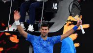 Serbia's Novak Djokovic celebrates after winning against Spain's Roberto Carballes Baena during their men's singles match on day two of the Australian Open tennis tournament in Melbourne early on January 18, 2023. (Photo by Paul CROCK / AFP) 
