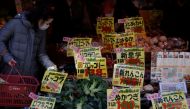 A shopper checks food items at a supermarket in Tokyo, Japan January 20, 2023. REUTERS/Issei Kato