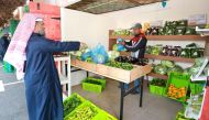 A customer buying vegetables at the Mahaseel Festival.