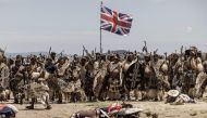 Amabutho Zulu regiments hold a British flag captured during the reenactment of the Battle of Isandlwana, in Isandlwana on January 21, 2023. The battle, fought on January 22, 1879 was the first major encounter in the Anglo-Zulu War between the British Empire and the Zulu Kingdom. (Photo by MARCO LONGARI / AFP)