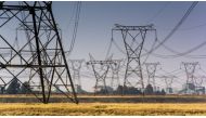 Electrical power lines hang from transmission pylons near to the Eskom Holdings SOC Ltd. Lethabo coal-fired power station in Vereeniging, South Africa, on Wednesday, Aug. 7, 2019. File Photo: Waldo Swiegers/Bloomberg

