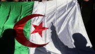 A demonstrator's shadow is cast on a national flag during an anti-government rally in Algiers, Algeria on December 24, 2019. File Photo / Reuters
