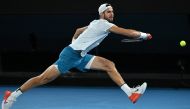Russia's Karen Khachanov hits a return against USA's Sebastian Korda during their men's singles quarter-final match on day nine of the Australian Open tennis tournament in Melbourne on January 24, 2023. (Photo by WILLIAM WEST / AFP)