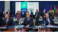 In this file photo taken on November 29, 2022 (left-right) US Secretary of State Antony Blinken, Sweden's Foreign Minister Tobias Billstrom and Finland's Foreign Minister Pekka Haavisto sit at their places prior to the start of a meeting of the North Atlantic Council (NAC) in the framework of a NATO Foreign Ministers session, with invitees from Finland and Sweden, in Bucharest, Romania. (Photo by Andrei PUNGOVSCHI / AFP)
 