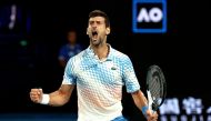 Serbia's Novak Djokovic reacts on a point against Russia's Andrey Rublev during their men's singles quarter-final match on day ten of the Australian Open tennis tournament in Melbourne on January 25, 2023. (Photo by DAVID GRAY / AFP) 