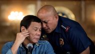 This file photo taken on January 30, 2017 shows then-Philippine President Rodrigo Duterte (left) talking to Philippine National Police director general Ronald Dela Rosa during a press conference at the Malacanang palace in Manila. (Photo by Noel Celis / AFP)